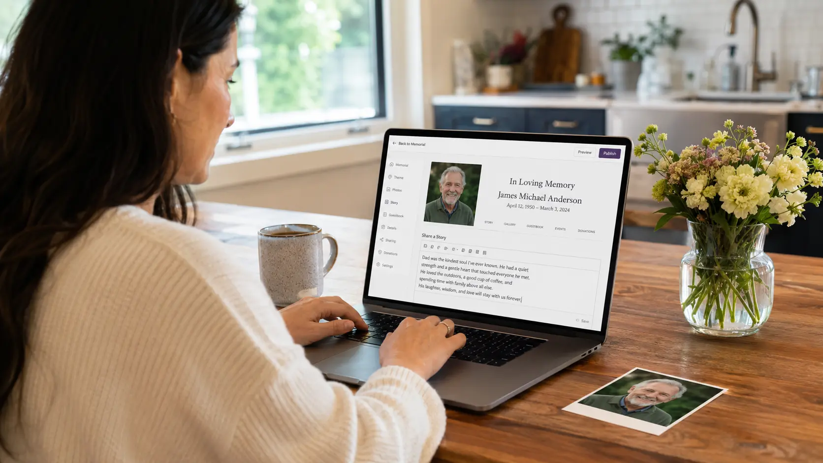 Creating an online memorial on a laptop in a kitchen