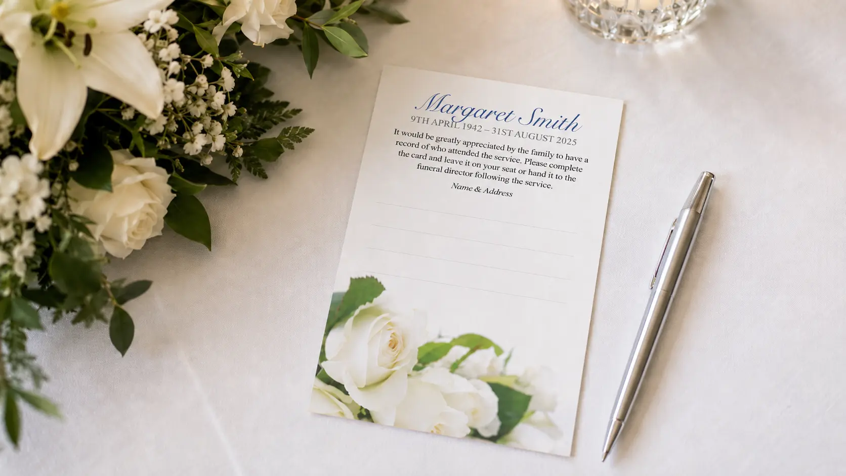 Blank Attendance Cards at a funeral service on a table with silver pen